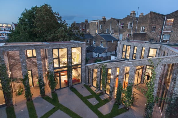 The richly textured communal courtyard is landscaped with a geometric mix of resin-bound gravel and planting beds, connecting back to...