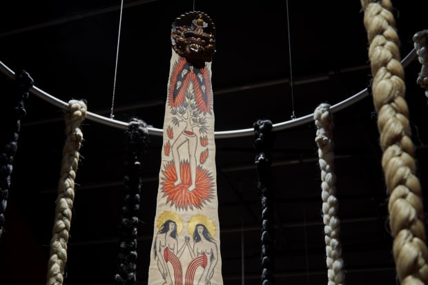 Act Two, 2024, Acrylic on python skin, artificial hair, and found wooden carved mask, Dimensions variable.