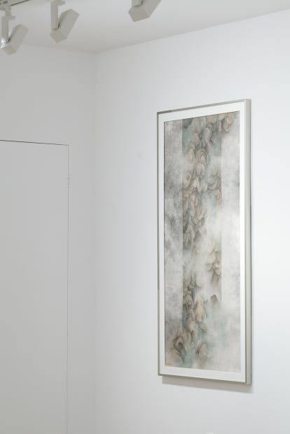 Yau Wing Fung's painting hanging on the wall, grey green color blocks with rich mountain texture at the center of the painting.