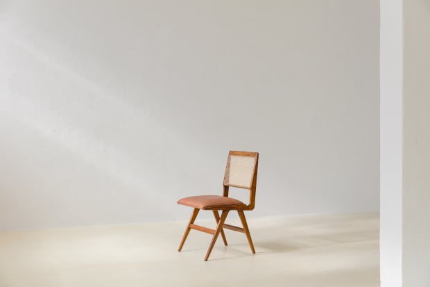 Unlike the cane tradition in Brazilian furniture, the cane weaving in this dining chair by Martin Eisler (1913-1977) presents rectangular...