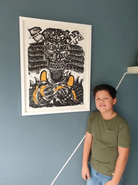 Young Art fan Daniël showing his specially signed Litho by Lieuwe in his room.