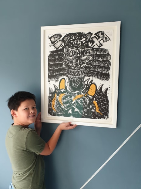 Young Art fan Daniël showing his specially signed Litho by Lieuwe in his room.