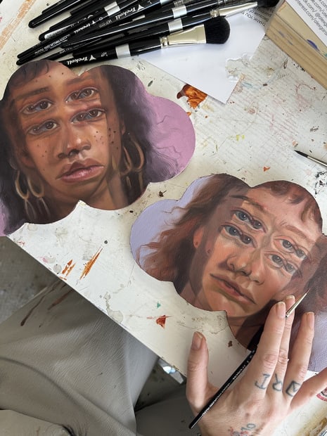 work in progress artworks by Alex Garant on cloud shaped canvases with the face of a woman