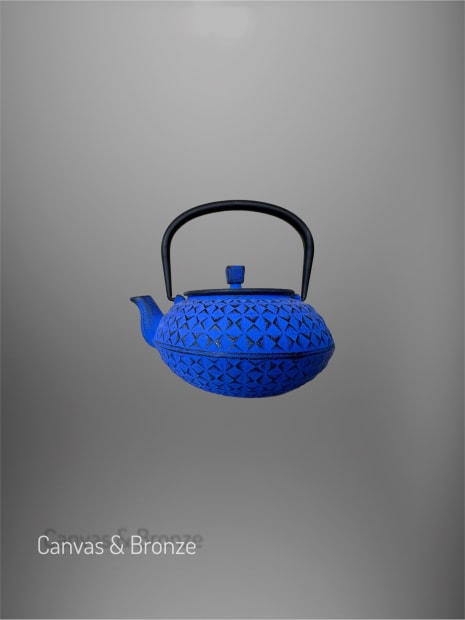Blue cast iron teapot with intricate textured patterns and a curved black handle on a gray background.