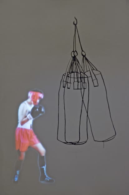 A second video installation is projected in the gallery window (Heavy Bag, 2010), also alluding to boxing: the artist's alter-ego...