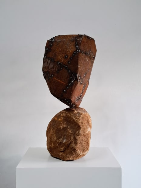 Q: You predominantly work with rocks, cement and found objects in your sculptures. Can you explain your choice of medium?...