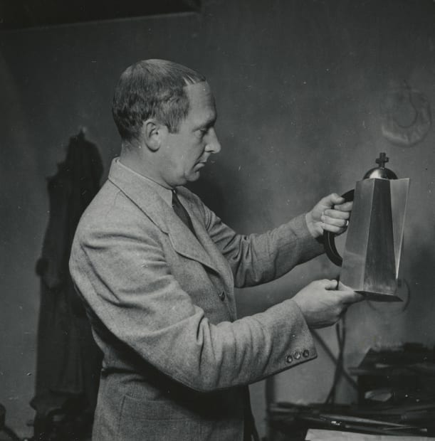 Wiwen Nilsson holding a communion wine jug.