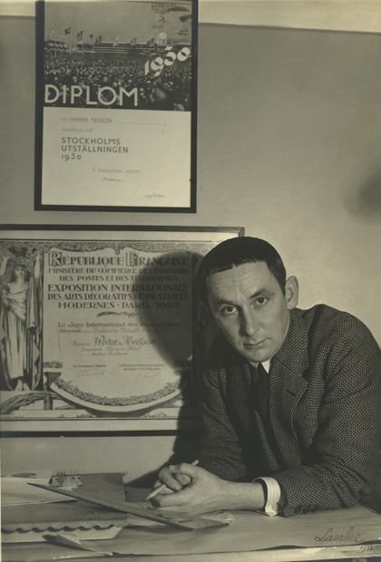 Wiwen Nilsson photographed in 1933 in front of his diplomas from the Exposition Internationale des Arts Décoratifs et Industriels Modernes in Paris, 1925, and the 1930 Stockholm Exhibition, Stockholm, Sweden.
