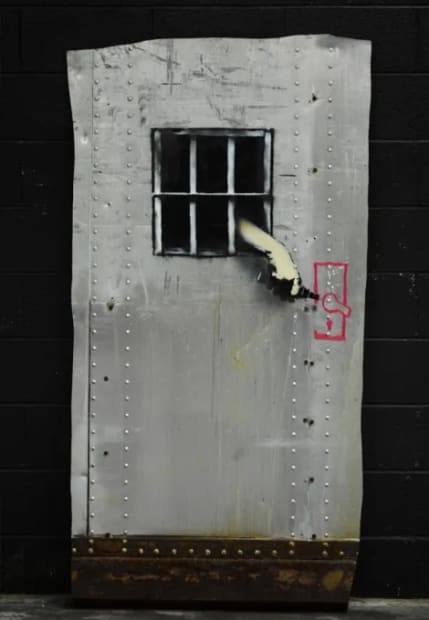 Banksy Jail Break 2010 stencil street art of prisoner attempting escape