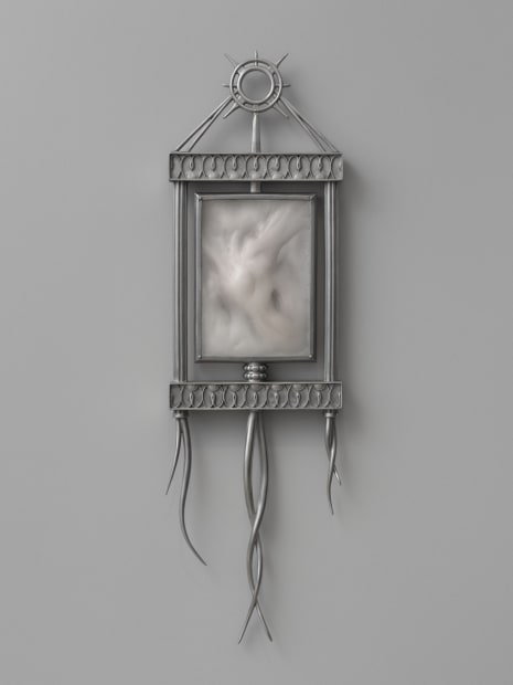 In Bašić's Fantasy vanishes in flesh (2025), ornate steel frames, crowned with a radiant halo signify an almost alchemical union...