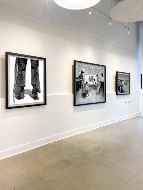 Cluster of Beau Simmons monochrome western prints creating a unified wall inside Buckhead Village gallery.