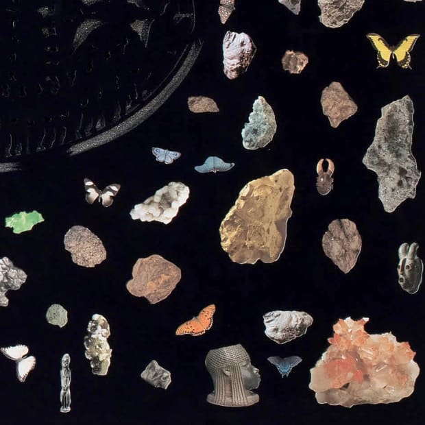 Detail from the left half of Villalongo's diptych showing rock crystals and African statuary against a black background.