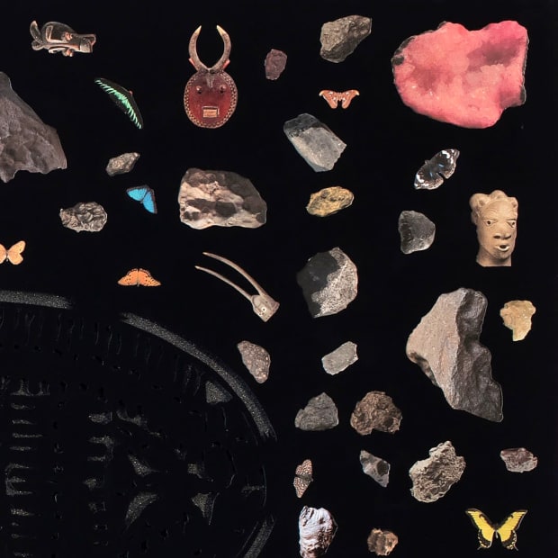 Detail from the left half of Villalongo's diptych showing rock crystals and African statuary against a black background.