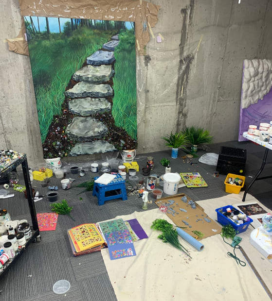studio shot of Nic Dyer painting of grass and steps