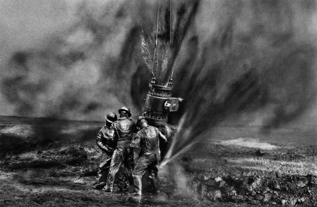 THE POWER OF PHOTOGRAPHY CDXXIX, Workers Struggle to Remove Bolts, Oil Wells, Kuwait, 1991 Signed, titled, & dated in pencil...