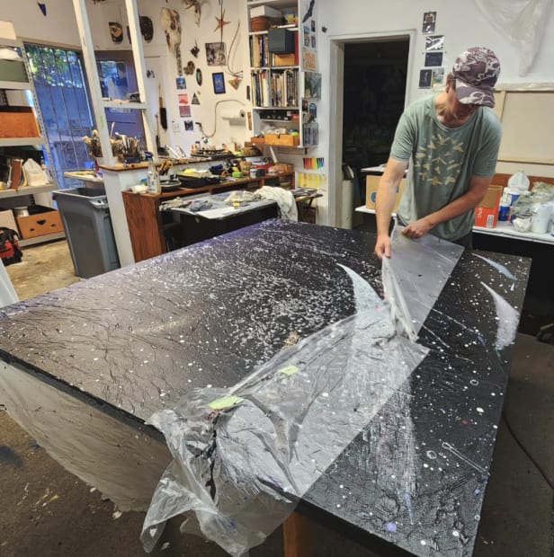 Decalcomania is a technique done by pressing something into wet paint, in this case a sheet of thin plastic, making...