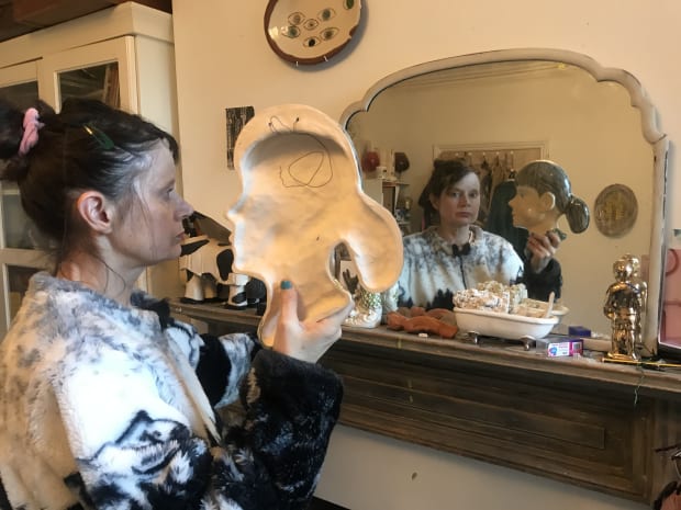 Karen DENSHAM’s Stork (2021), shrouded in a black hood, recalls to mind witches and Philip Guston’s hooded and masked figures...