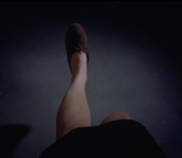 Sat in her studio, partially undressed, the artist films at close-range her own feet, knees, tights, a hand, while drawing...