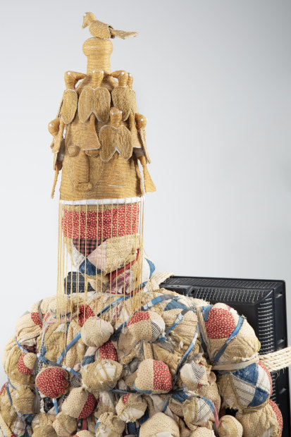 vanessa german TV Man, 2022 wood, cloth, cutter quit, glitter, sequined fabric, Yoruba hat found stuck to a shelf at...