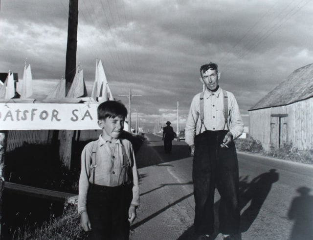 Lida Moser Gaspé Peninsula Québec, 1950 Signed, titled, dated and annotated "Mittuard and his son on roadside selling boats", in pencil, au verso Printed circa 1980 image on 11 x 14 inch (27.94 x 35.56 cm) Gelatin silver paper 10 1/2 x 13 1/2 in 26.67 x 34.29 cm