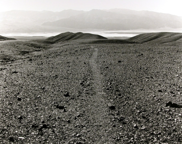 Mark Ruwedel 1954- Death Valley (Lake Manly) Ancient Footpath from Nevares Springs to the Lake, 1996/2003 Titled, in pencil, on mount recto Signed, titled, and dated, in pencil, on mount verso Gelatin silver print mounted to 24 x 28 inch (60.96 x 71.12cm) archival board 16 x 20 in 40.64 x 50.8 cm Edition of 10