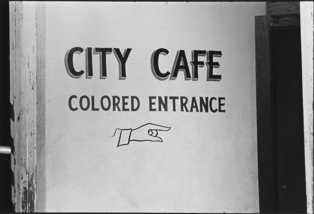 Danny Lyon b. 1942 The entrance to the City Café, Selma, Alabama, 1964 Signed, dated, and annotated, in pencil, with Bleak Beauty printer stamp, in ink, au verso Printed by Lupe Alvarez in 1993 Gelatin silver print 8 ¾ x 12 ¾ inch (22.23 x 32.39 cm) image 11 x 14 inch (27.94 x 35.56 cm) paper