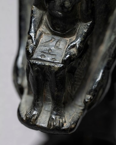 Egyptian theophorous figure, holding a seated statuette of Imhotep, Late Period, 27th-30th Dynasty, c.525-343 BC