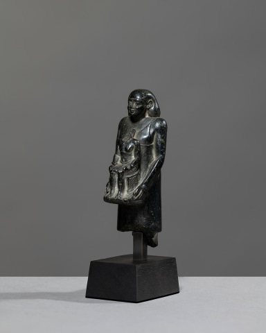 Egyptian theophorous figure, holding a seated statuette of Imhotep, Late Period, 27th-30th Dynasty, c.525-343 BC