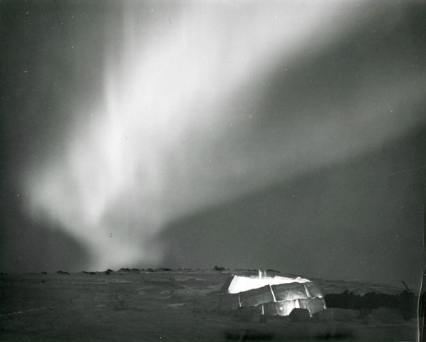 Richard Harrington, Northwest Territories, Northern lights flare over lantern lighted igloo, 1950