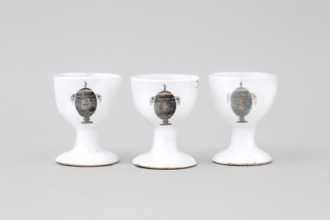 THREE UNUSUAL CHINESE ARMORIAL EGG-CUPS, Qianlong (1736-1795)