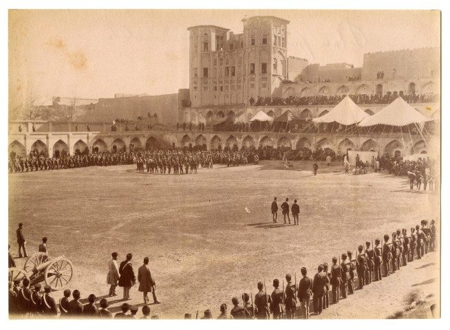 Antoin Sevruguin, Military ceremony in a meydan in Kermanshah, with Takieh Bozorg in the background, Late 19th Century