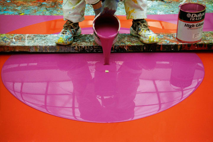 The artist working on Poured Painting: Magenta, Orange, Magenta, 1999