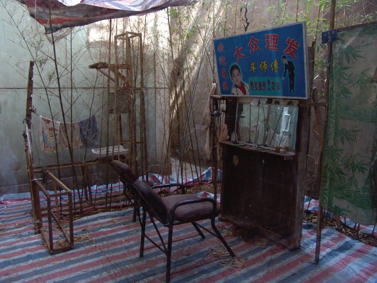 An open-air barber shop surrounded by bamboos