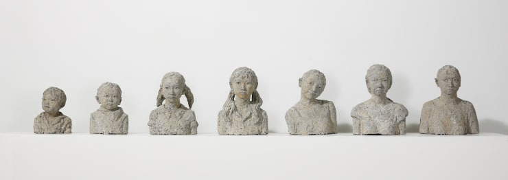 Seven papier mache bust sculptures that represent different ages of Artist Chen Qiulin from her childhood to adulthood.
