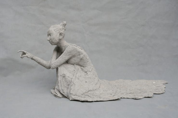 A girl scratches the wall.