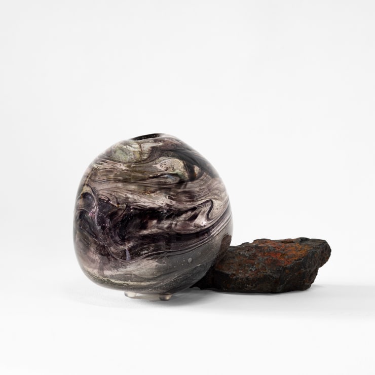 Benjamin Knock 1990 ~ PresentCore Vessel, 2024 Handblown optical grade Kugler glass and uranium glass resting on igneous basalt 52-60% feldspar plagioclase, 12% pyroxene , 20% quartz (Collaboration with Glass Technician - Ned Reily, Melting Pot Glass Studio) 13 × 16.5 × 13 cm
