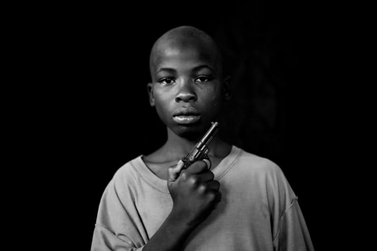 Mário Macilau, A Boy with his toy pistol, Growing in Darkness series, 2012