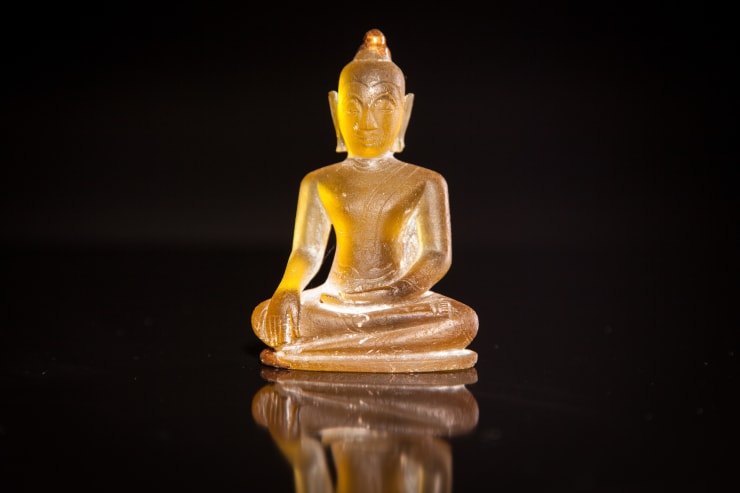 A Rare Honey Yellow Coloured Glass Buddha Seated In Bhumisparsha Mudra