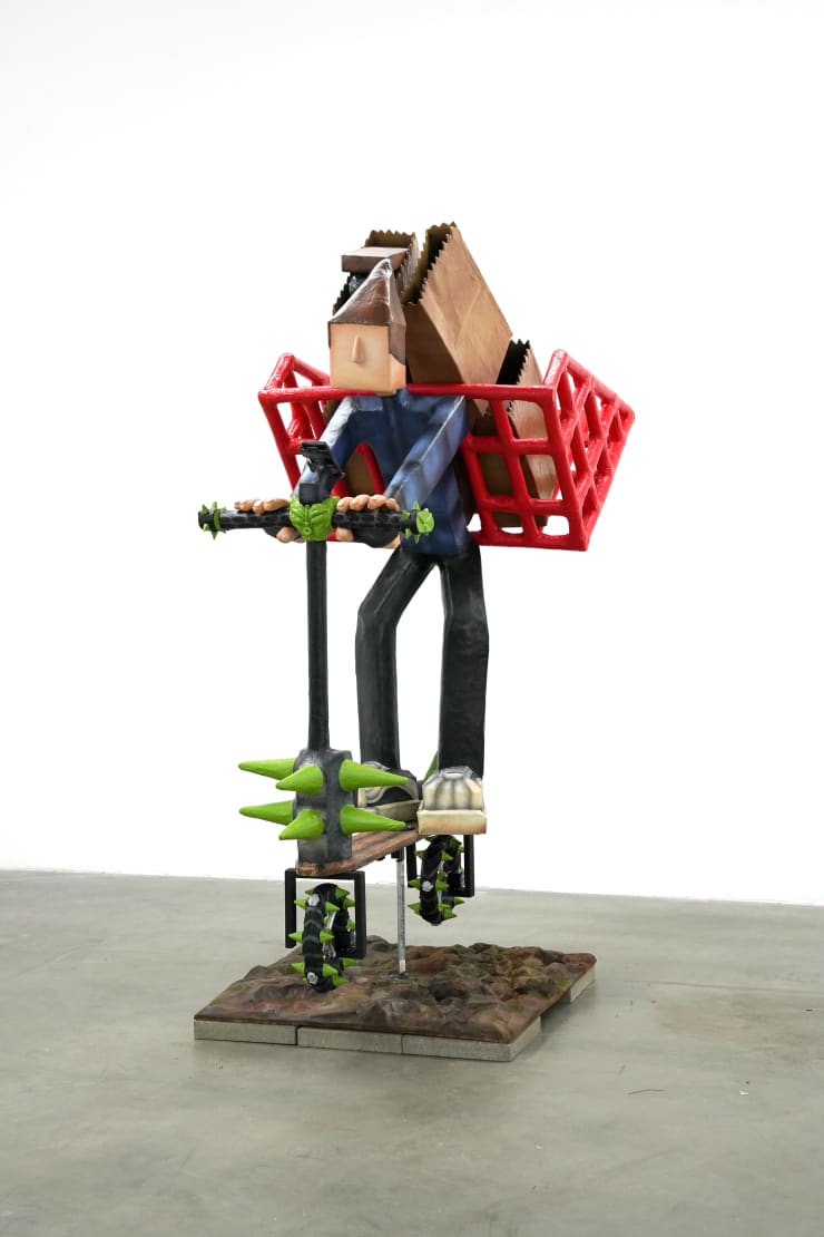 sculpture of a man on a scooter