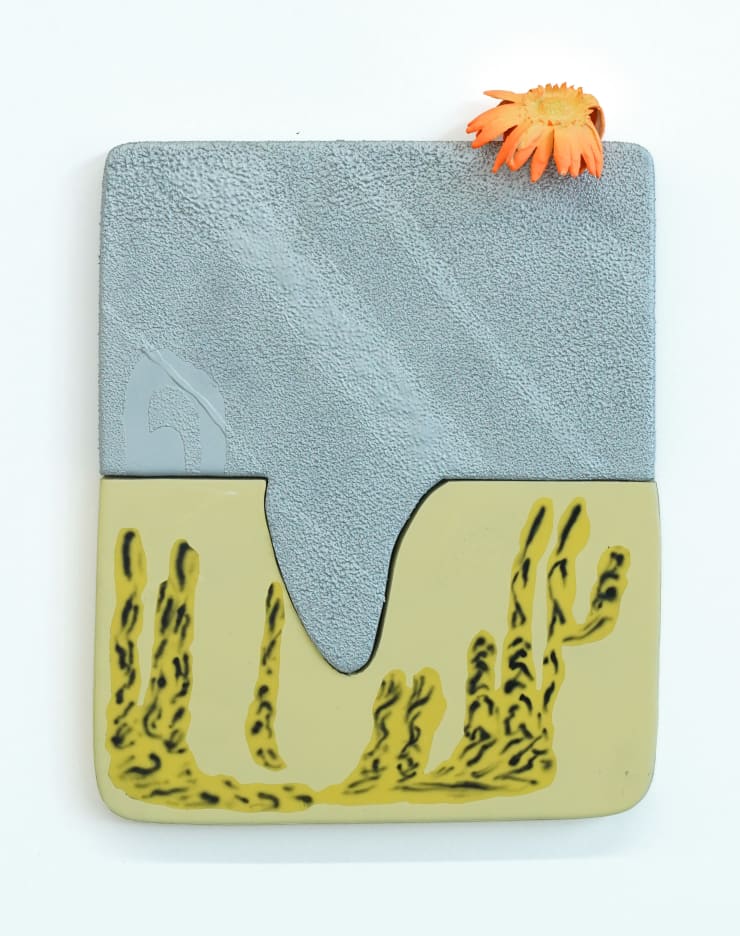 abstract sculpture with orange flower