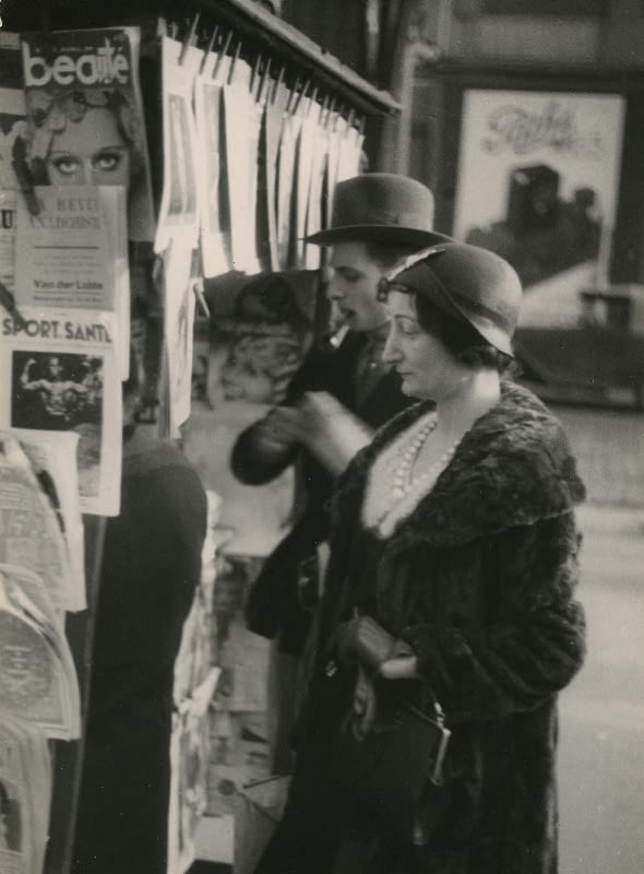 Man and Woman at News Stand