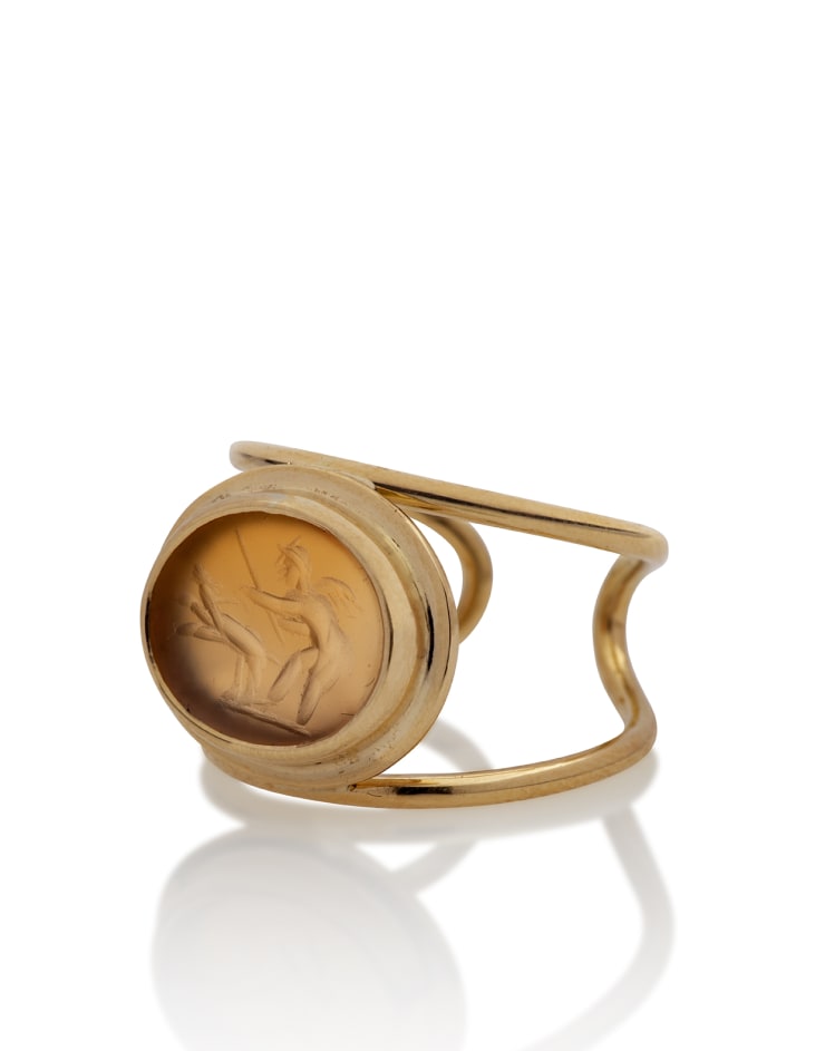 Roman, A Roman carnelian intaglio of an erote and a dog set in a modern gold ring, circa 1st - 2nd century AD