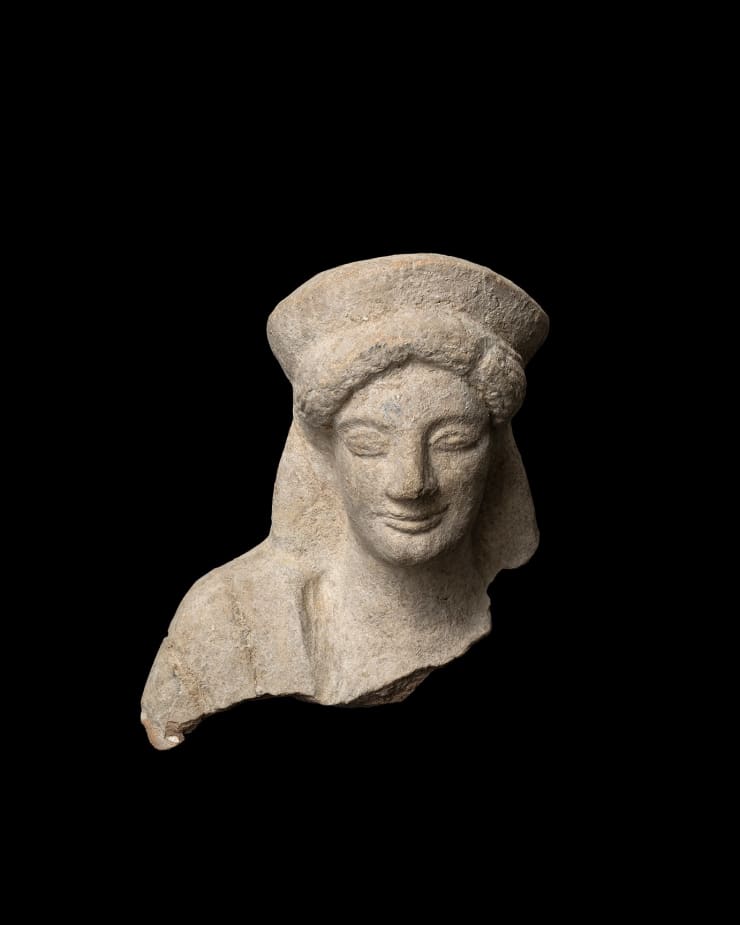 Greek, A Greek terracotta head of a kore, Archaic, circa 5th century BC