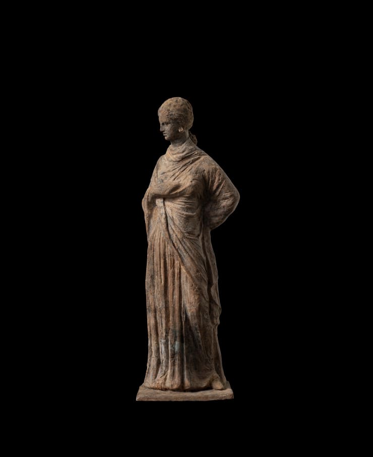 Greek, A Greek terracotta draped female figure, circa 4th - 3rd century BC