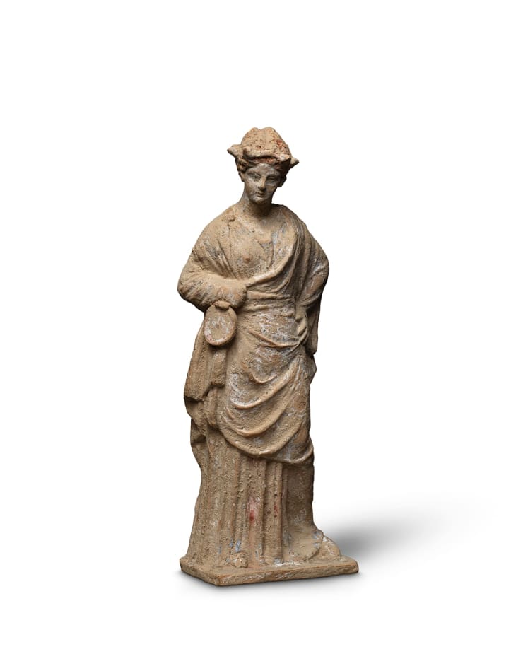 Greek, A Greek terracotta draped female figure, Hellenistic, circa 3rd century BC