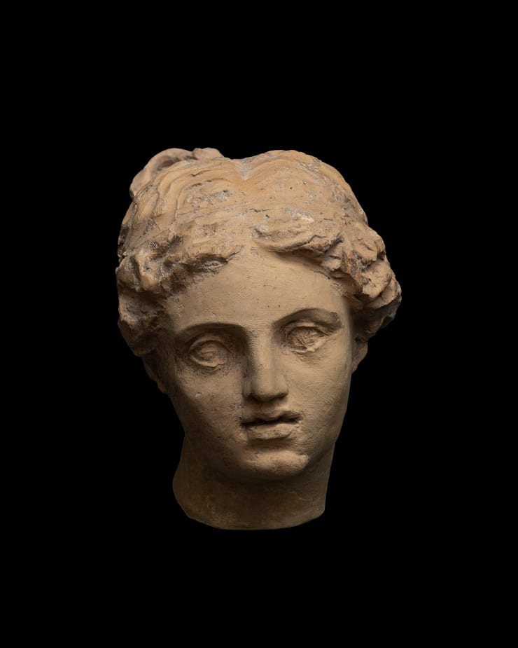 Greek, A Greek terracotta head of Aphrodite, Hellenistic, circa 3rd century BC