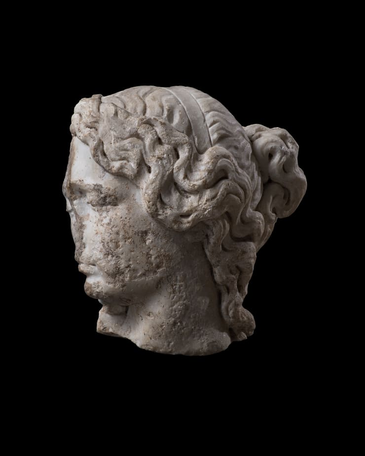 Roman, A Roman marble fragmentary head of a sleeping woman, circa 2nd century AD