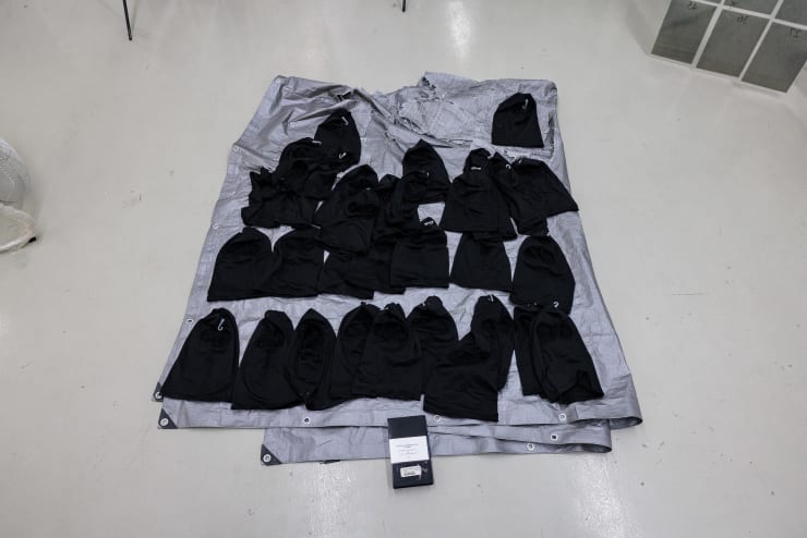 Allen-Golder Carpenter Nighthawks + ink jet, 2025 ski masks, tarp, VHS cassette + prints on paper (taped to wall) 194 x 148 cm