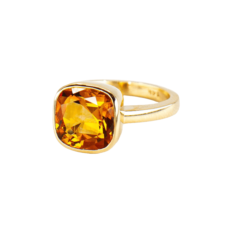 Gold ring with faceted orange stone