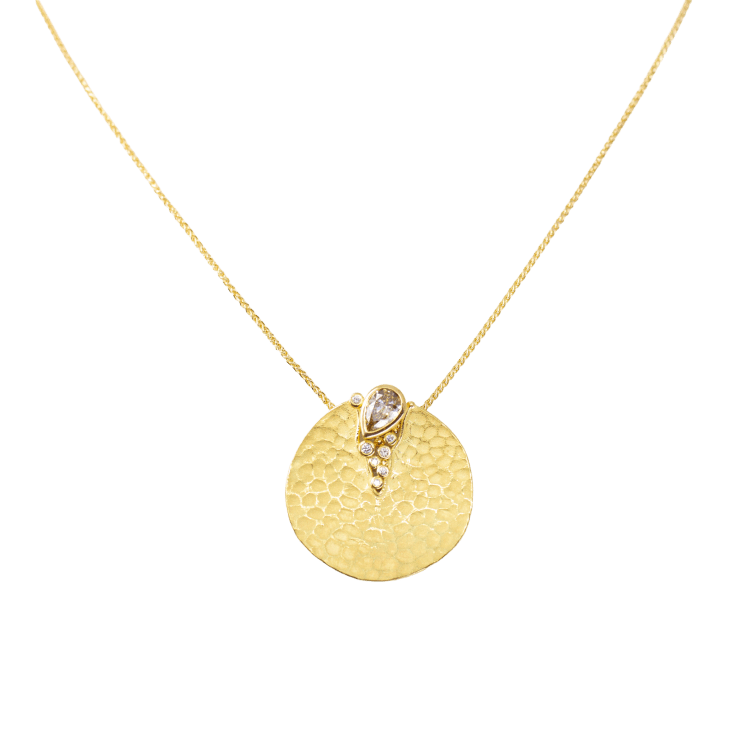 Yellow gold disk pendant with brown and white diamonds by Fringe Gallery studio jeweler Barbara Heinrich